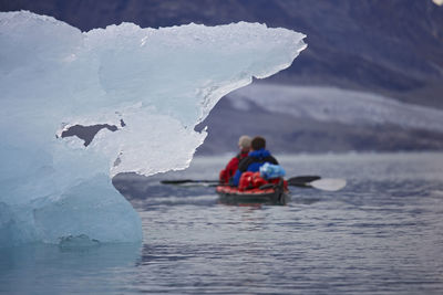 2 men traveling with a sea kayak in eastern greenland