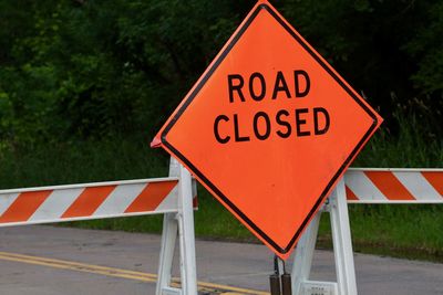 Close-up of road sign against plants