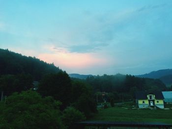 Scenic view of field against cloudy sky