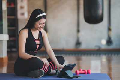 Young woman exercising in gym