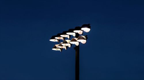 Low angle view of illuminated floodlight at night