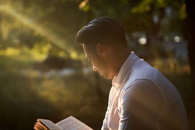 Side view of young man looking outdoors
