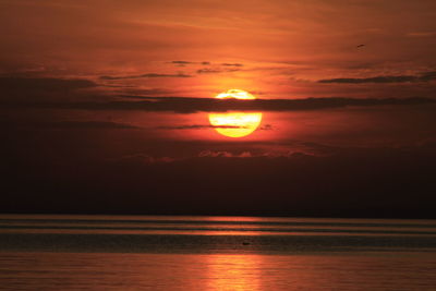 Scenic view of sea against orange sky