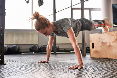 Full length of young woman lying on floor