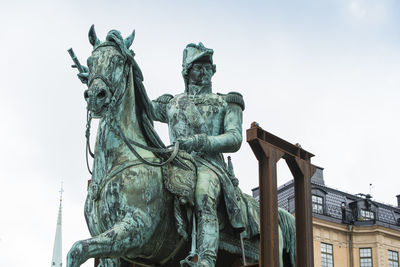 Low angle view of statue against sky