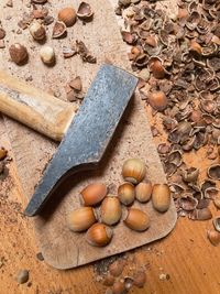 High angle view of nuts next to hammer