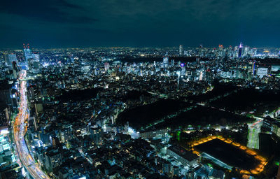 High angle view of city lit up at night