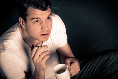 Portrait of young man smoking