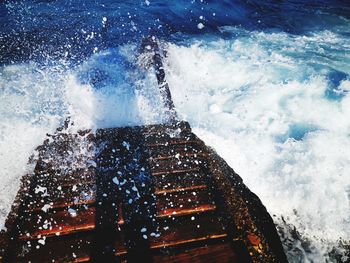 Water splashing in sea against sky