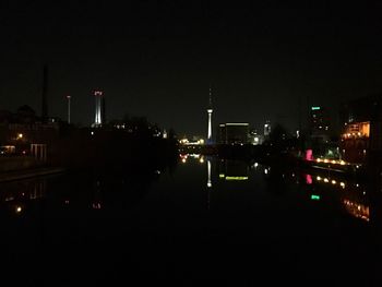 Illuminated city against sky at night