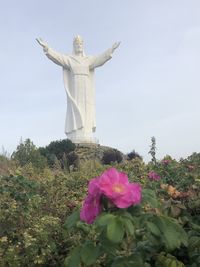 Statue of flower against sky