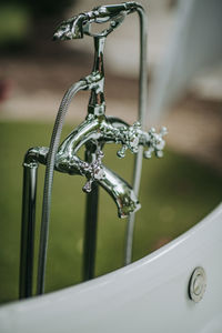 Close-up of faucet in water