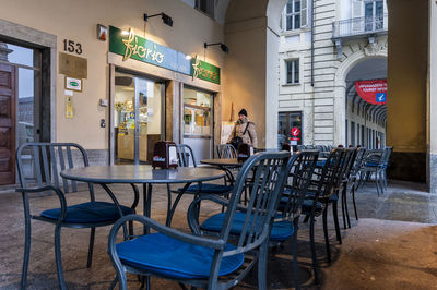 Empty chairs and tables in city