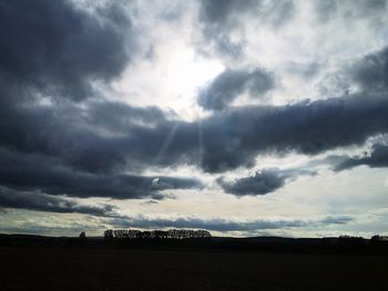 Scenic view of silhouette field against sky