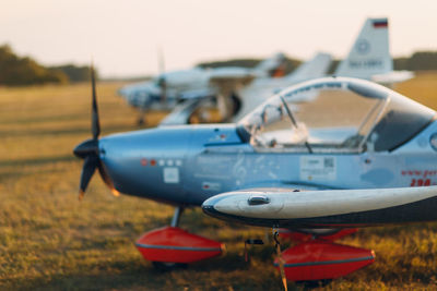 Close-up of airplane on airport runway against sky