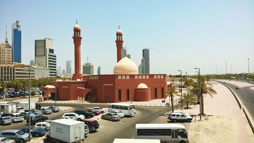 View of mosque buildings in city against sky