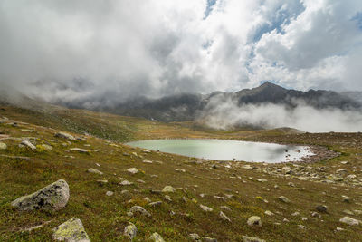 Scenic view of land and mountains against sky