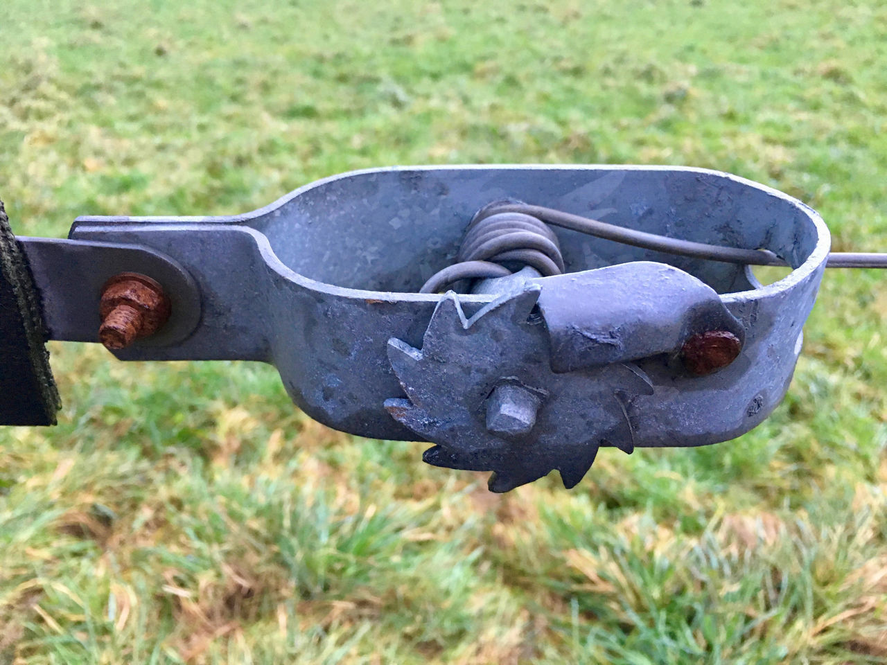 CLOSE-UP OF ABANDONED METAL ON FIELD