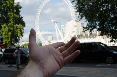 Cropped image of person hand on city street