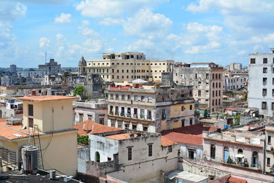 High angle view of buildings in town against sky