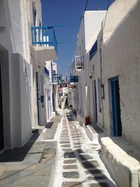 Narrow alley amidst buildings in city mykonos greece