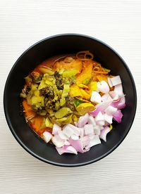 High angle view of chopped vegetables in bowl on table