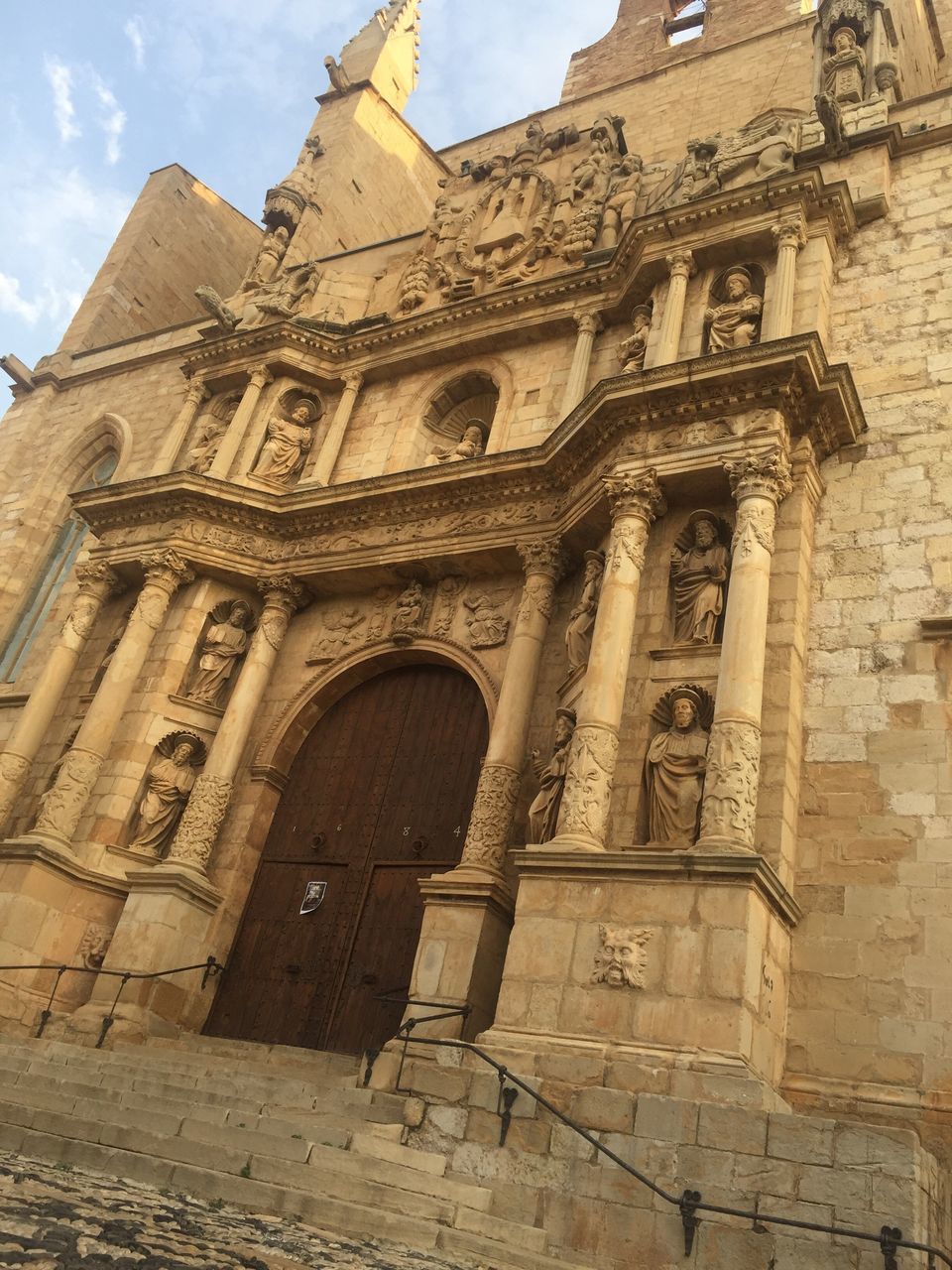 architecture, history, built structure, low angle view, building exterior, no people, religion, day, sky, outdoors, travel destinations, sculpture, ancient civilization