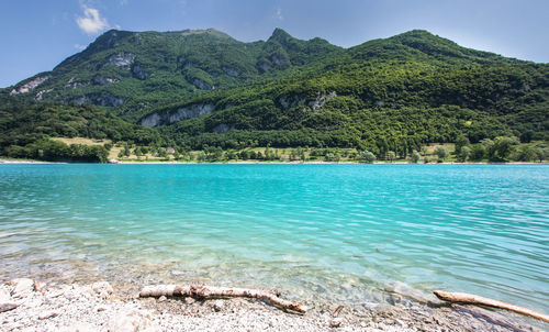 Scenic view of lake tenno and mountains against sky italy