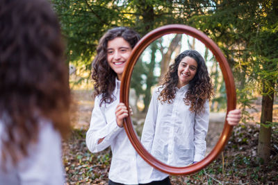 Portrait of a smiling young woman standing outdoors