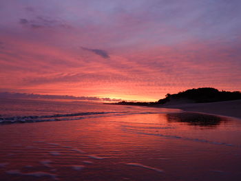 Scenic view of sea against romantic sky at sunset