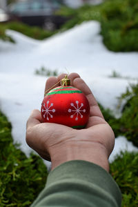 Close-up of hand holding strawberry