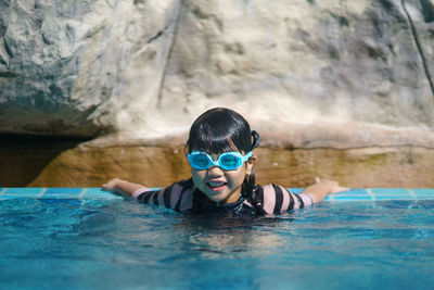 Portrait of boy swimming in pool