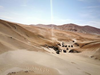 Vehicles on road along desert