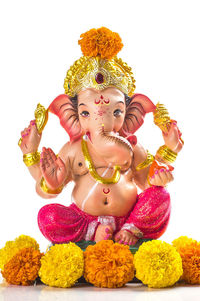 Low angle view of buddha statue against white background