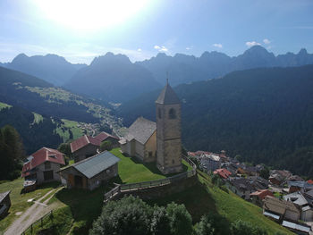 Panoramic view of houses and mountains against sky