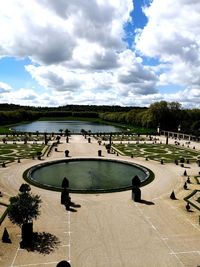 High angle view of park by lake against sky