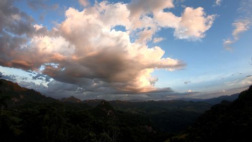 Scenic view of landscape against dramatic sky