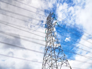 Low angle view of electricity pylon against sky