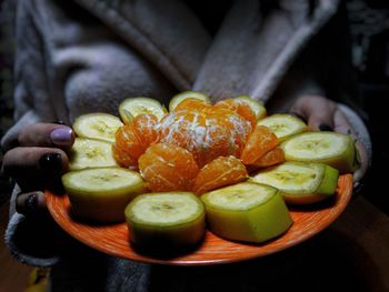 Close-up of hand holding fruits