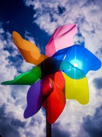 Low angle view of multi colored pinwheel against sky