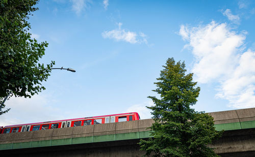 Low angle view of train on bridge against sky