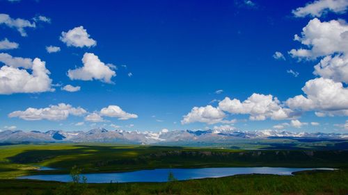 Scenic view of lake against blue sky