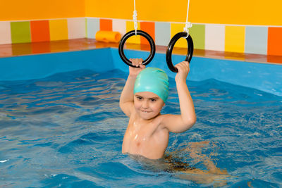 Shirtless boy in swimming pool