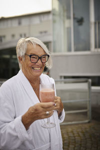 Senior woman holding smoothie