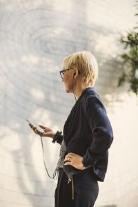 Mature businesswoman using mobile phone in creative office