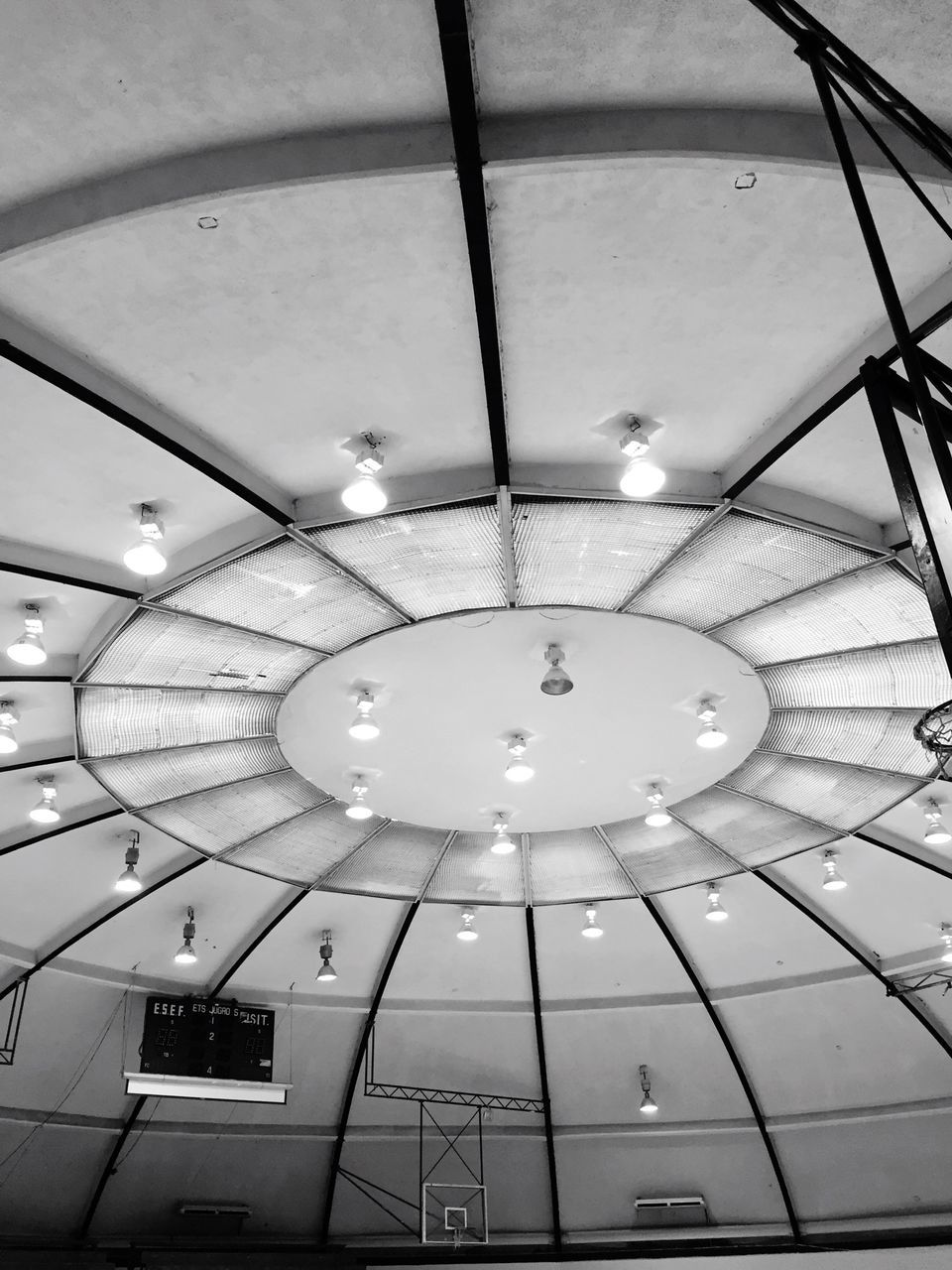 ceiling, low angle view, indoors, lighting equipment, illuminated, architecture, built structure, directly below, circle, hanging, geometric shape, electricity, electric light, modern, skylight, pattern, pendant light, sphere, technology, no people