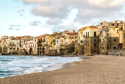 Buildings by sea at beach