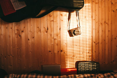 Sunlight falling on wooden wall at home