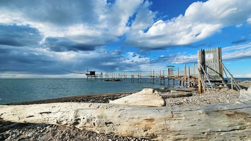 Scenic view of sea and trabucco against sky punta aderci nature riserve in vasto abruzzo italy