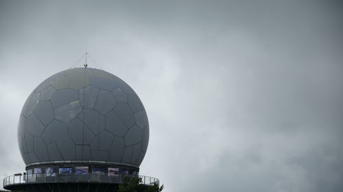 Low angle view of tower against cloudy sky